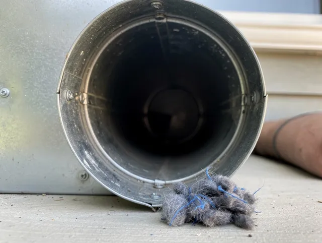 La Crescenta-Montrose Dryer Vent Cleaning technician using specialized equipment to clear severe dryer vent blockage in La Crescenta-Montrose
